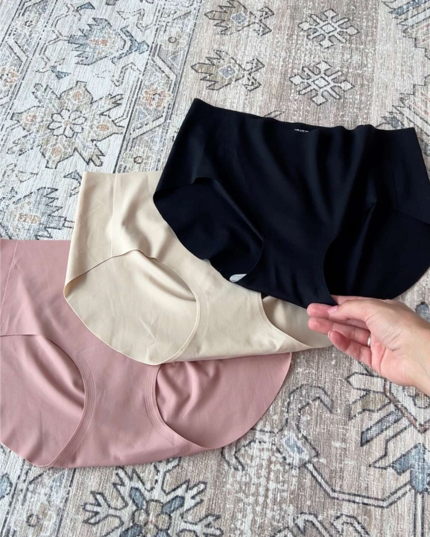 Three pairs of seamless underwear on carpet