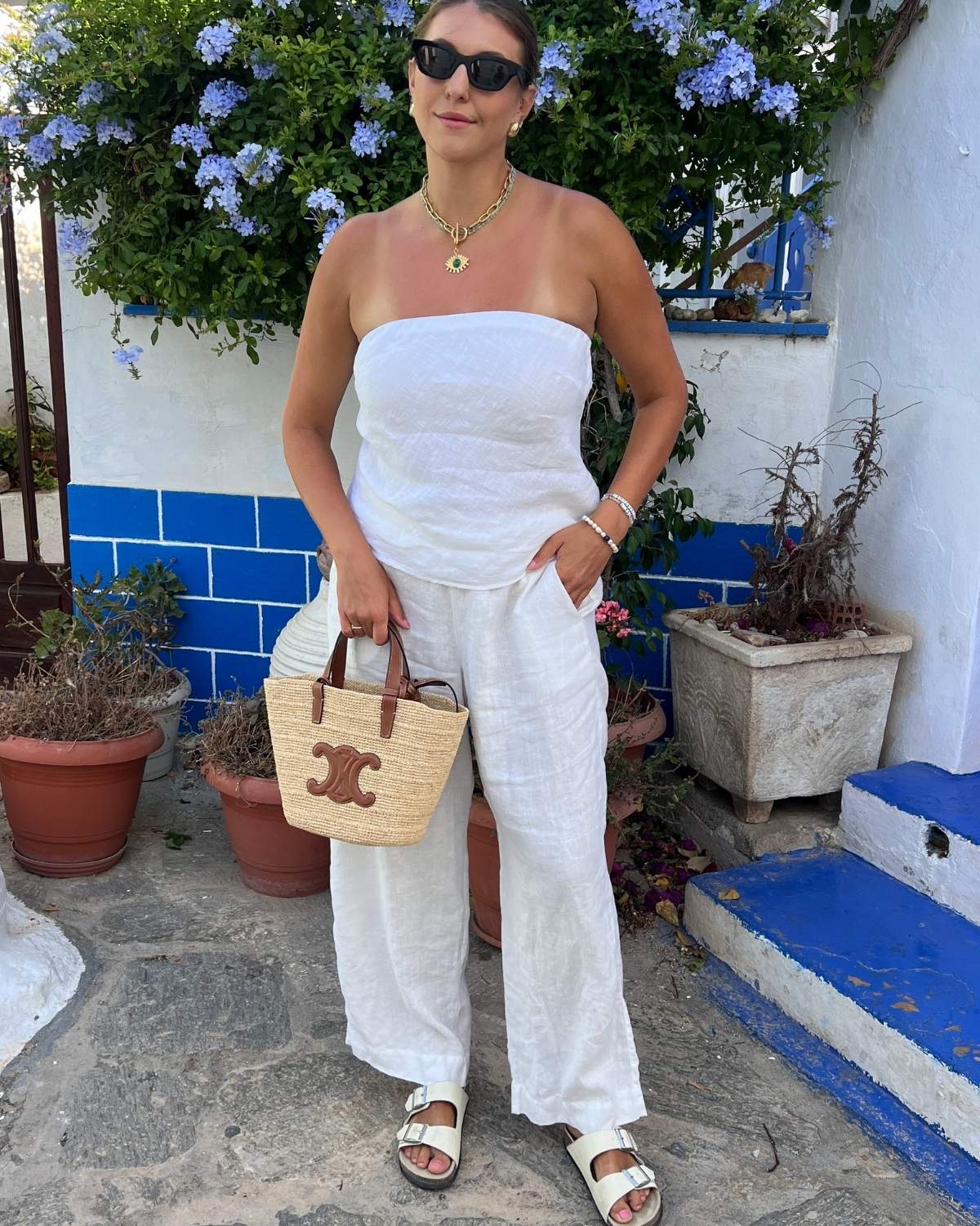 Woman with large bust wearing strapless linen outfit demonstrating styling with supportive undergarments