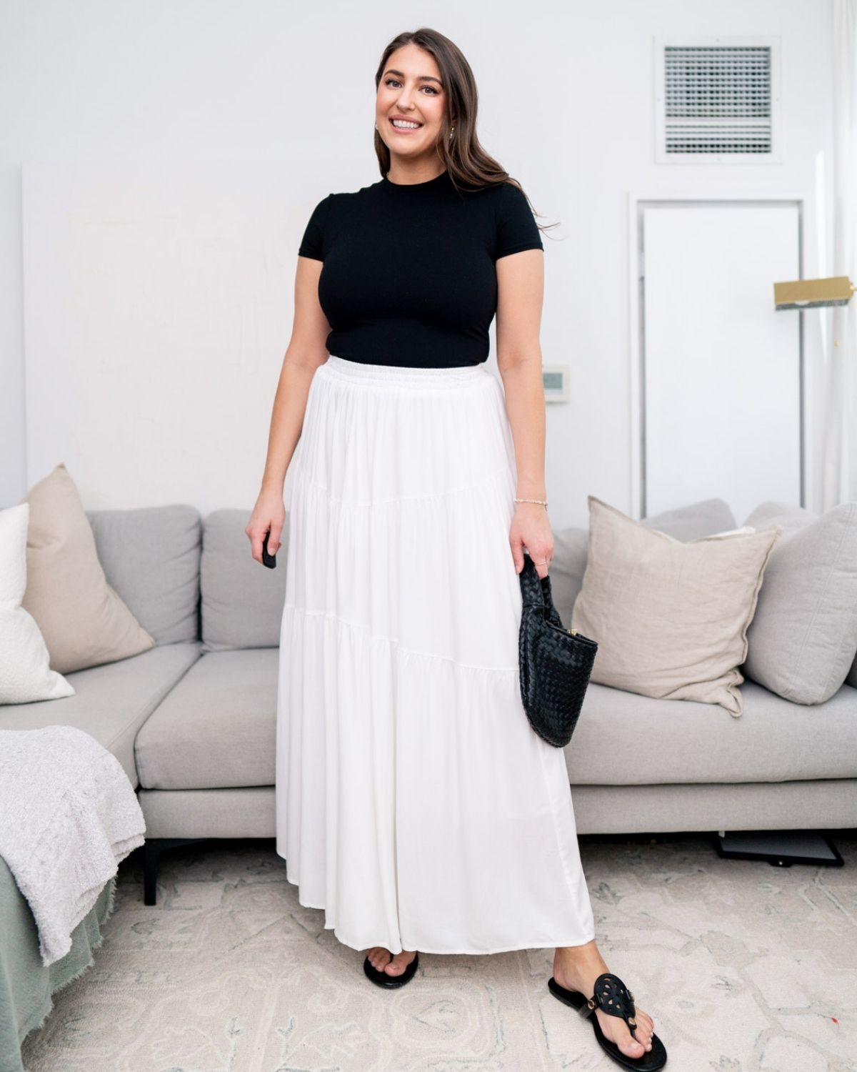 Woman with a large bust wearing a tight black top showing how fitted fabric emphasizes chest size