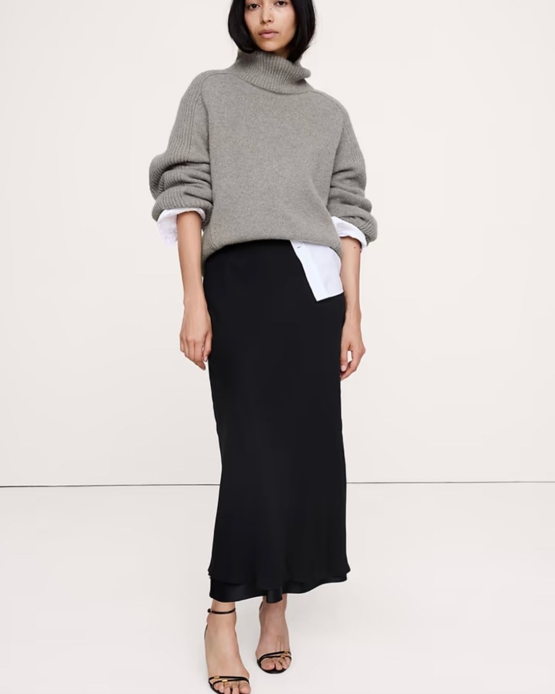 Black column skirt styled with an oversized sweater for fall